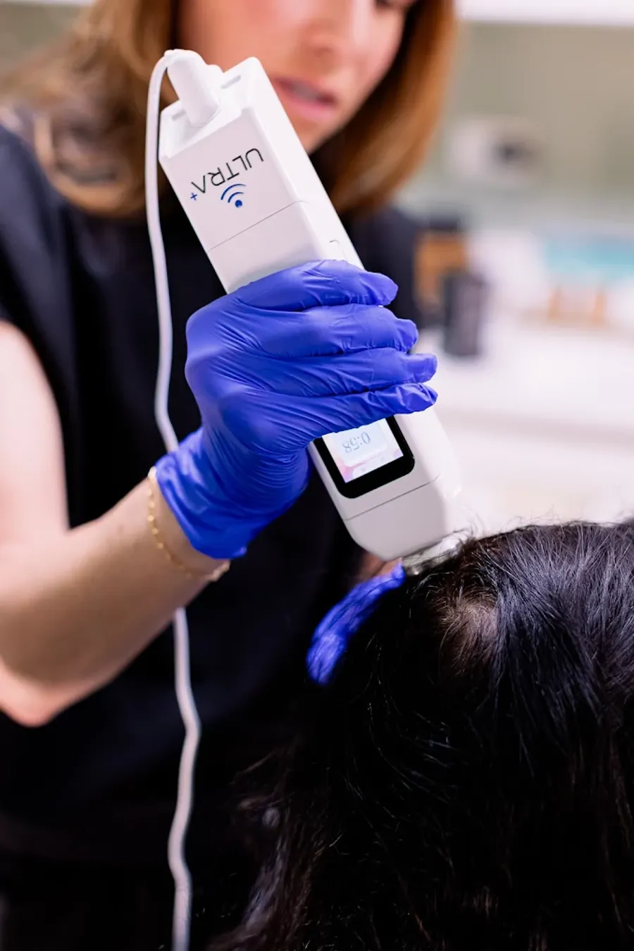 Lyndsay performing a hair regeneration treatment